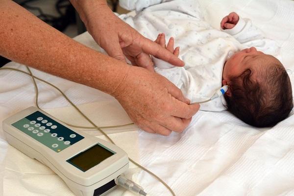 Baby asleep while getting a hearing screening