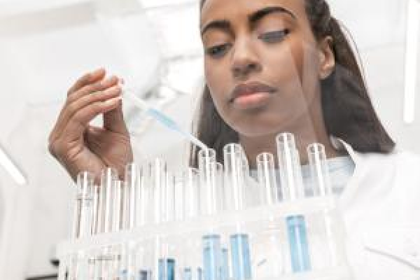 A woman in a laboratory holding viles.